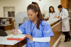 Black nurse charting Fotolia